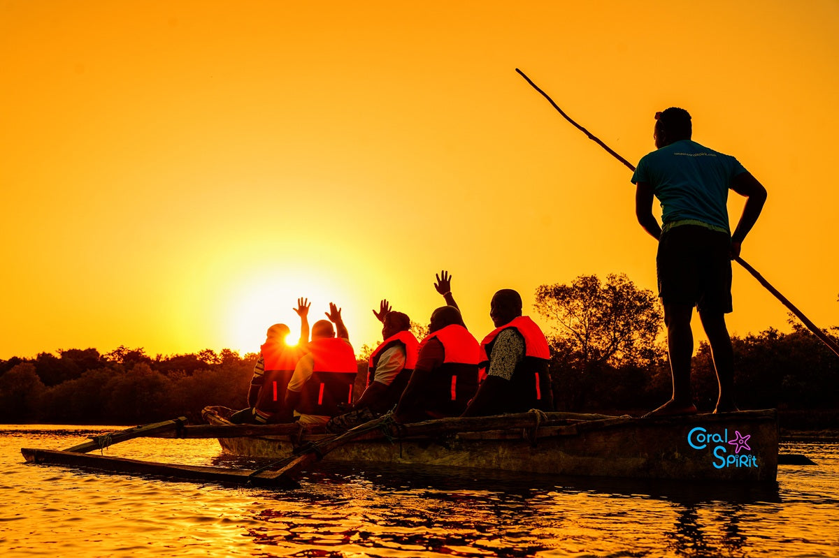 People on a raft with a guide at sunset on a river